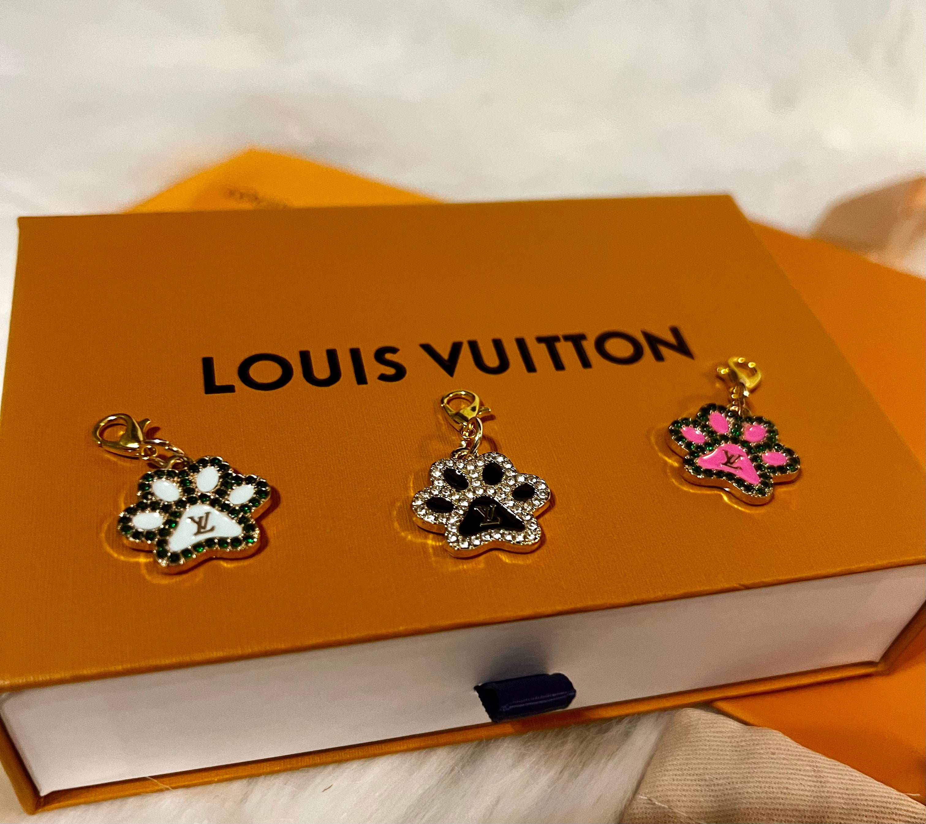 Featuring our LOUIS VUITTON Paw Print Charm Collection