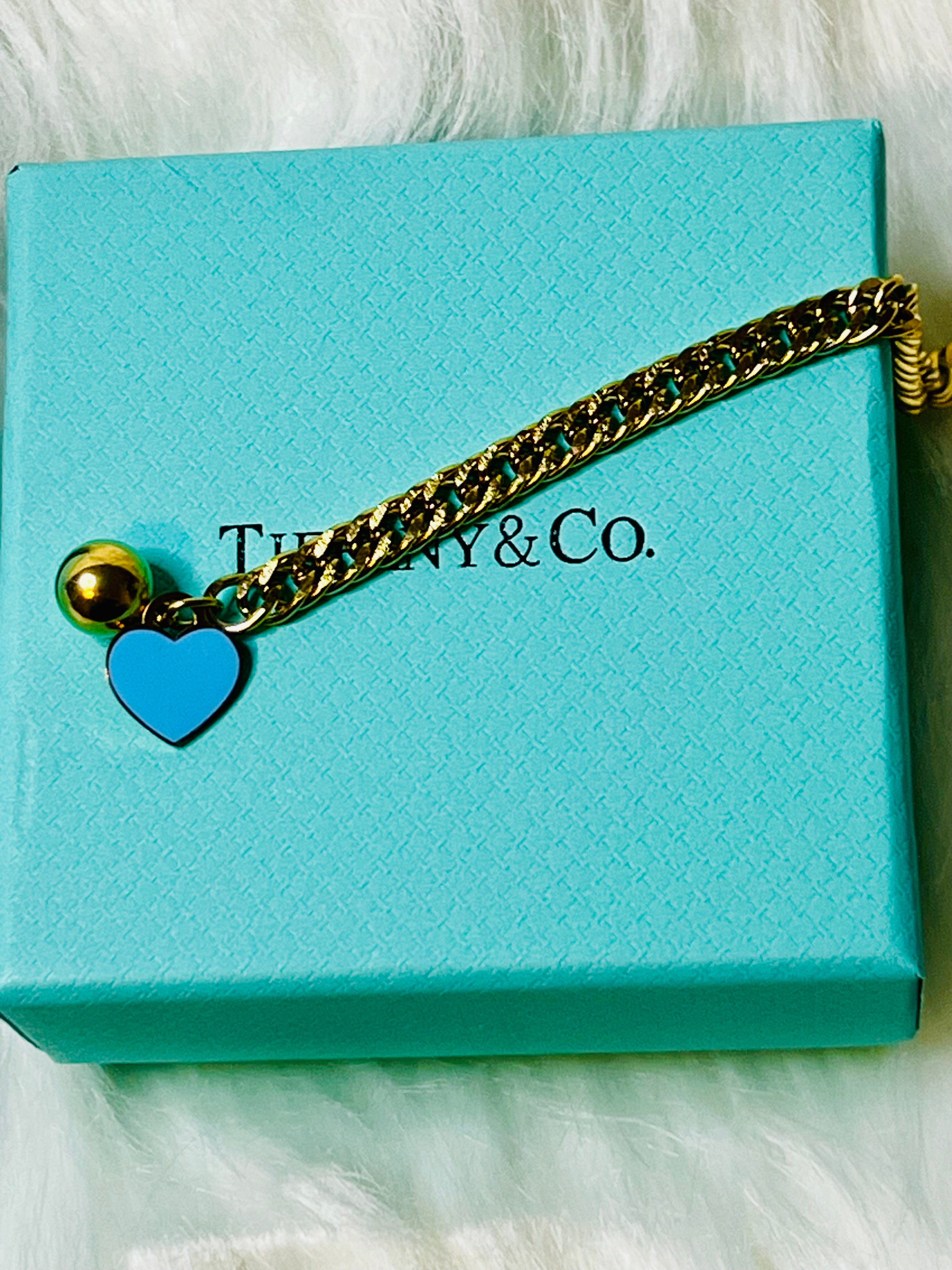Tiffany & Co. Iconic Please Return to Tiffany Gold Woven Bracelet with Heart Shaped Blue & Gold Ball Dangle