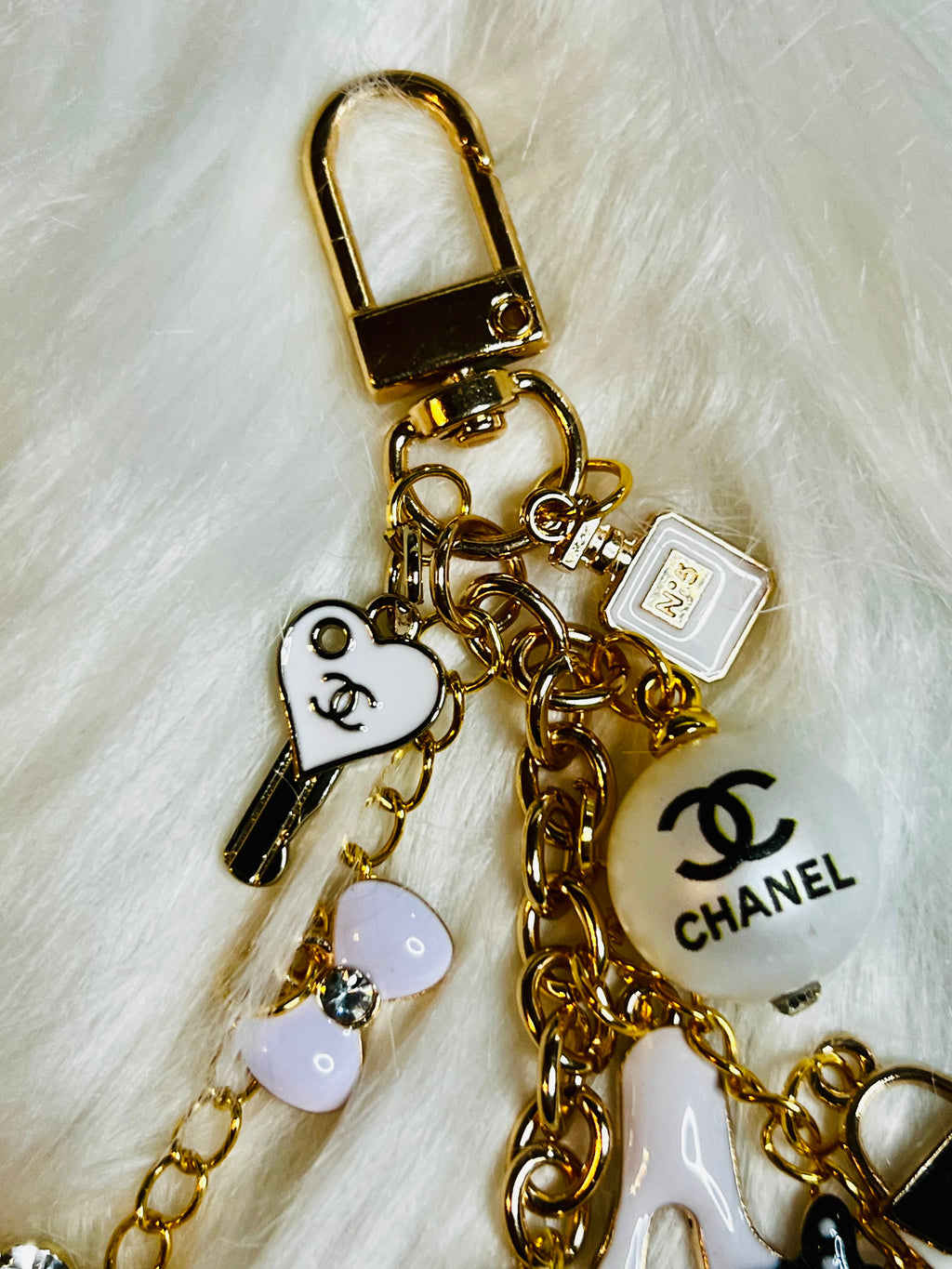 CHANEL Gold, White, and Black Pearl Logo Charm Keychain