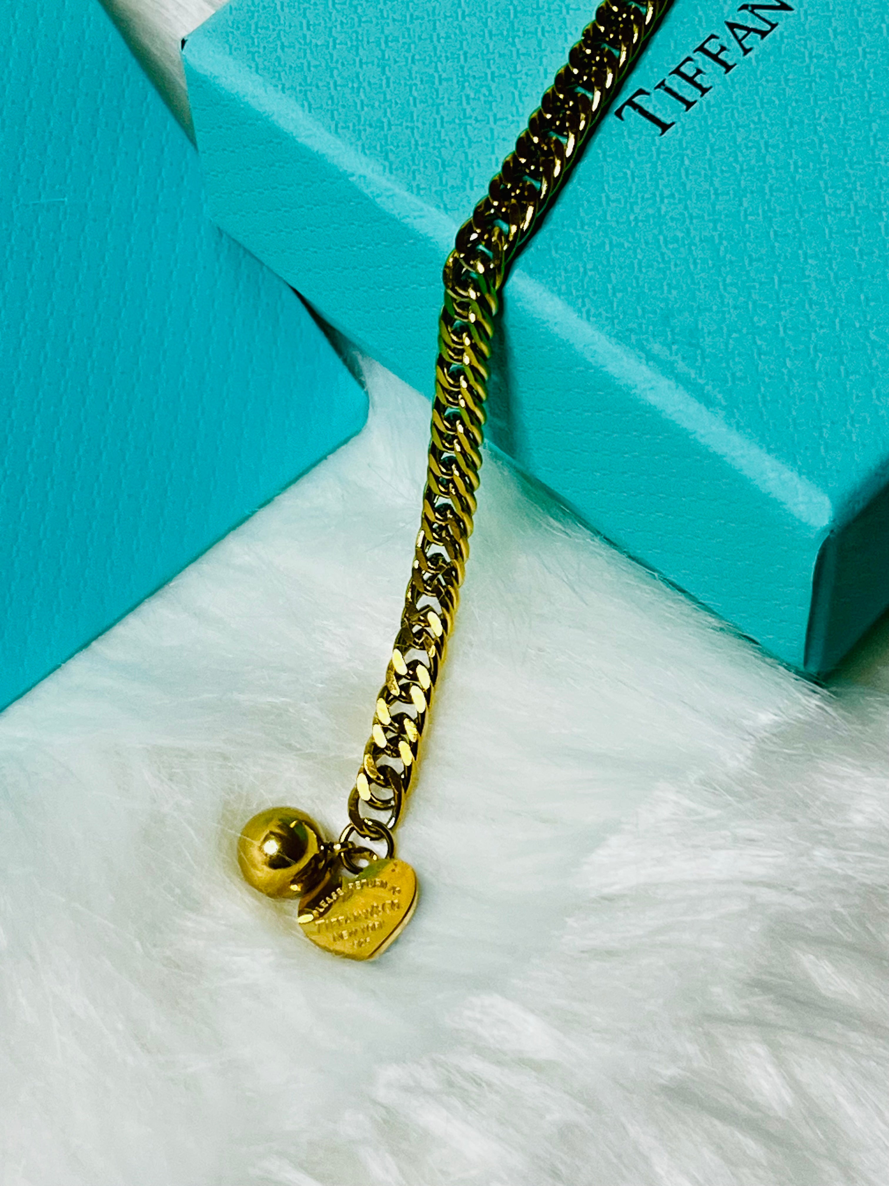 Tiffany & Co. Iconic Please Return to Tiffany Gold Woven Bracelet with Heart Shaped Blue & Gold Ball Dangle