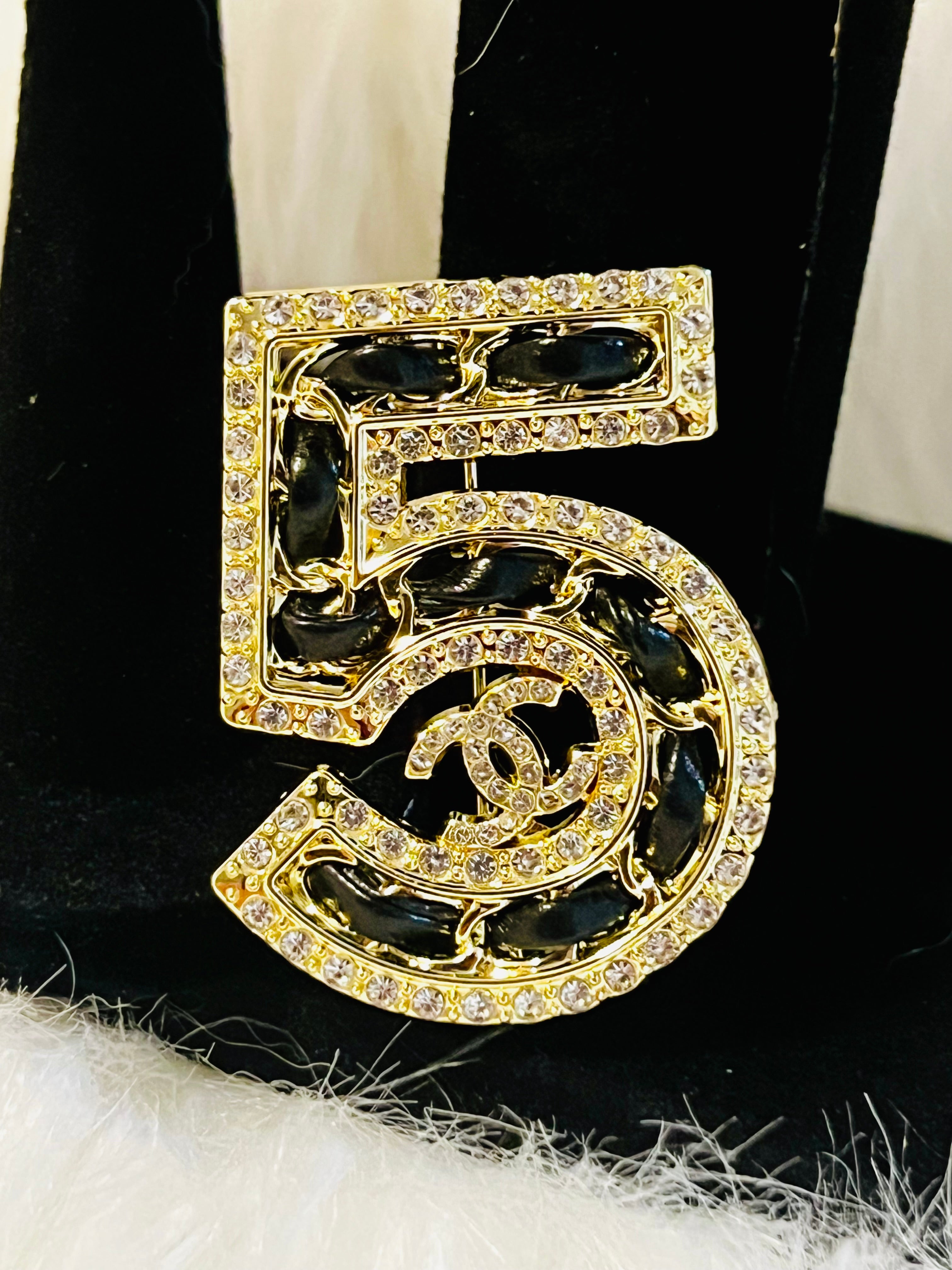 Iconic CHANEL NO 5 Gold with Rhinestone Accent Black Braided Brooch