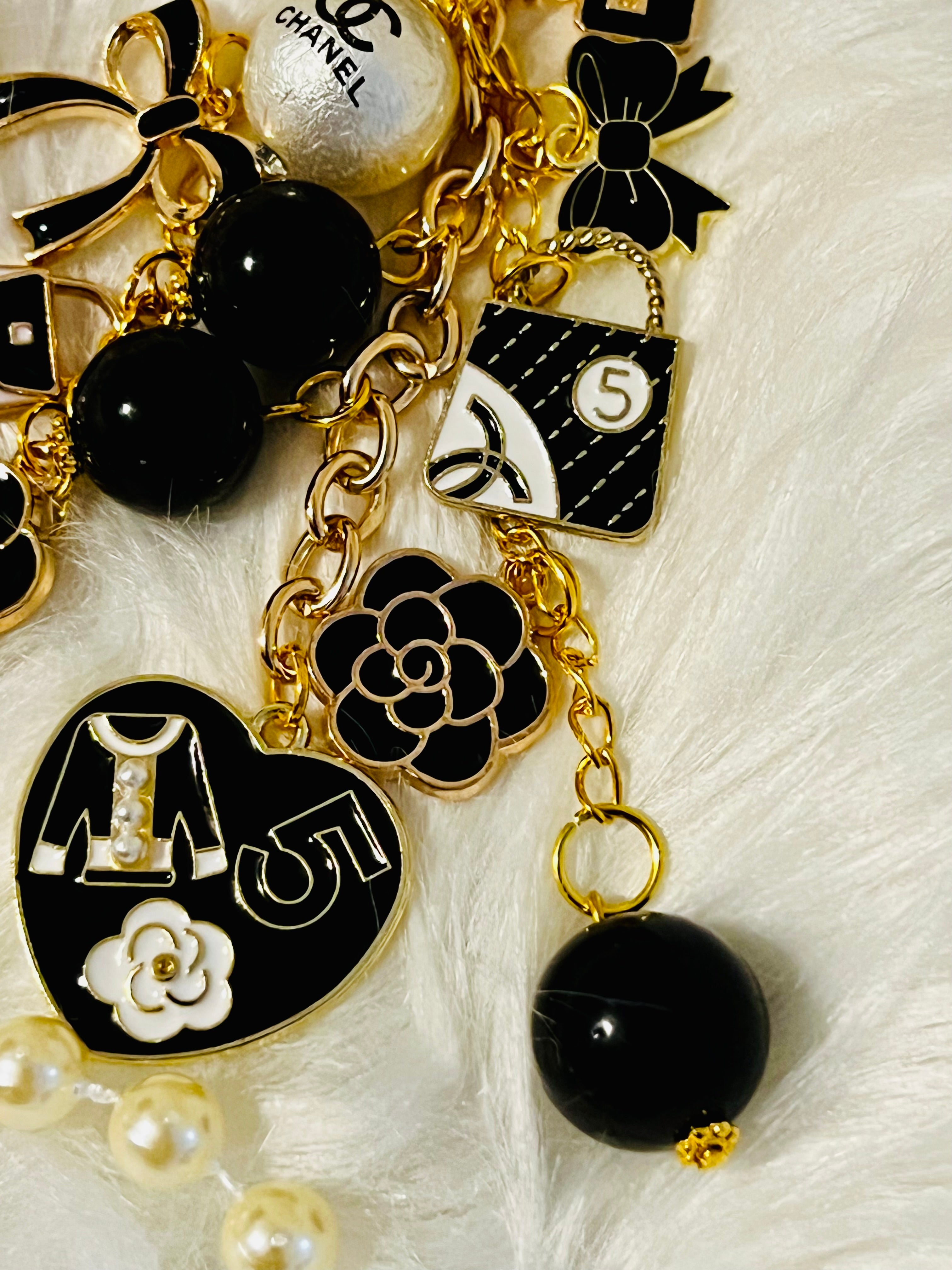 Chanel inspired black pearl bag charm-gold multi-charm with no 5 heart, camellia, bow-styled on classic flap