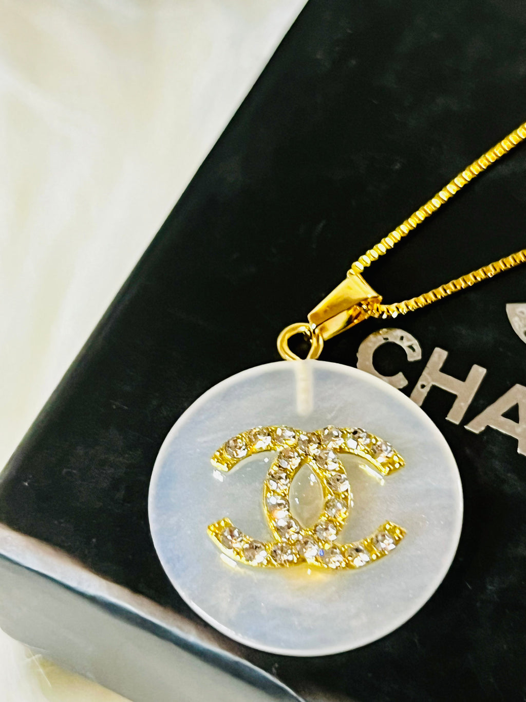 CHANEL White Shell with Gold Lettering Circular Pendant Necklace