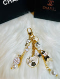 CHANEL Gold, White, and Black Pearl Logo Charm Keychain