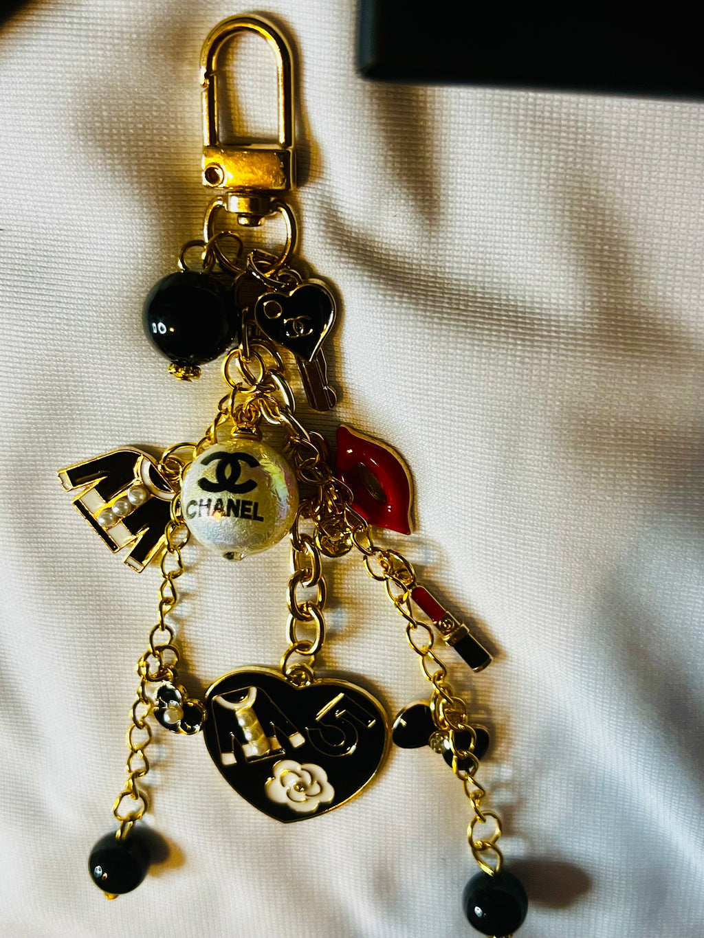 CHANEL Gold Keychain with Black Charms