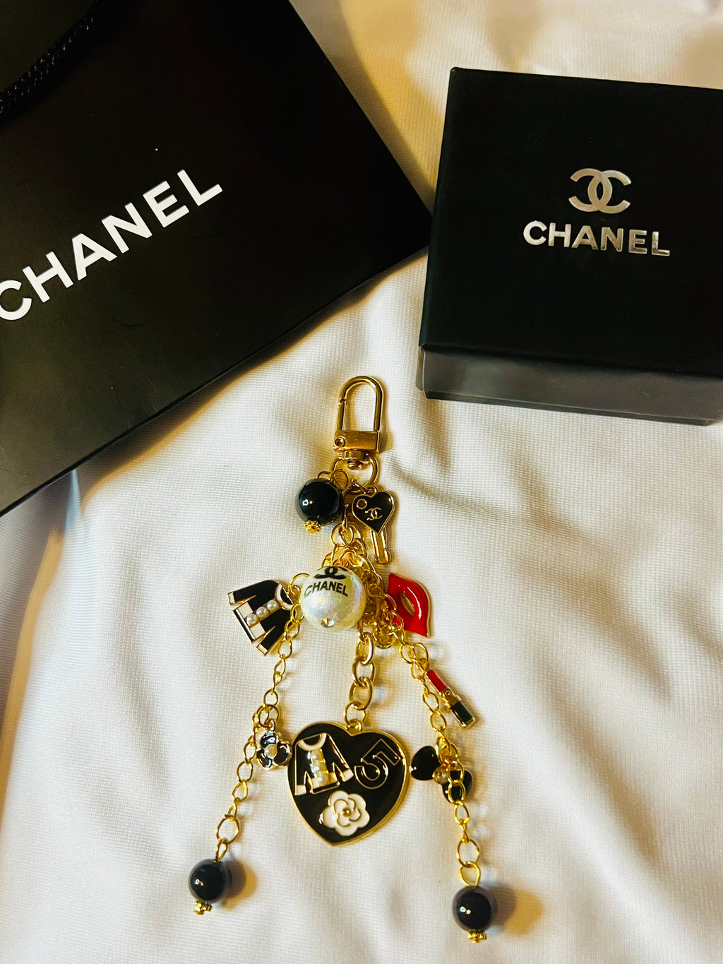 CHANEL Gold Keychain with Black Charms