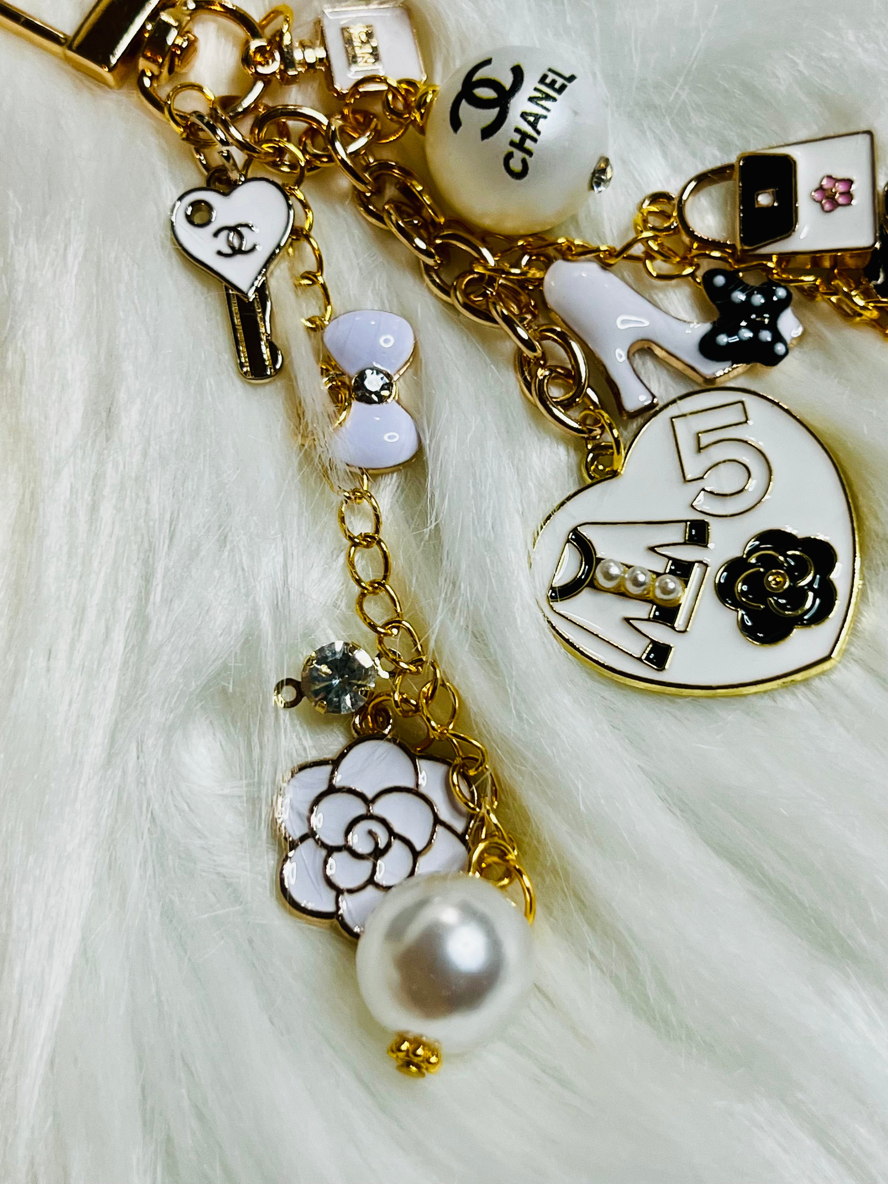 CHANEL Gold, White, and Black Pearl Logo Charm Keychain