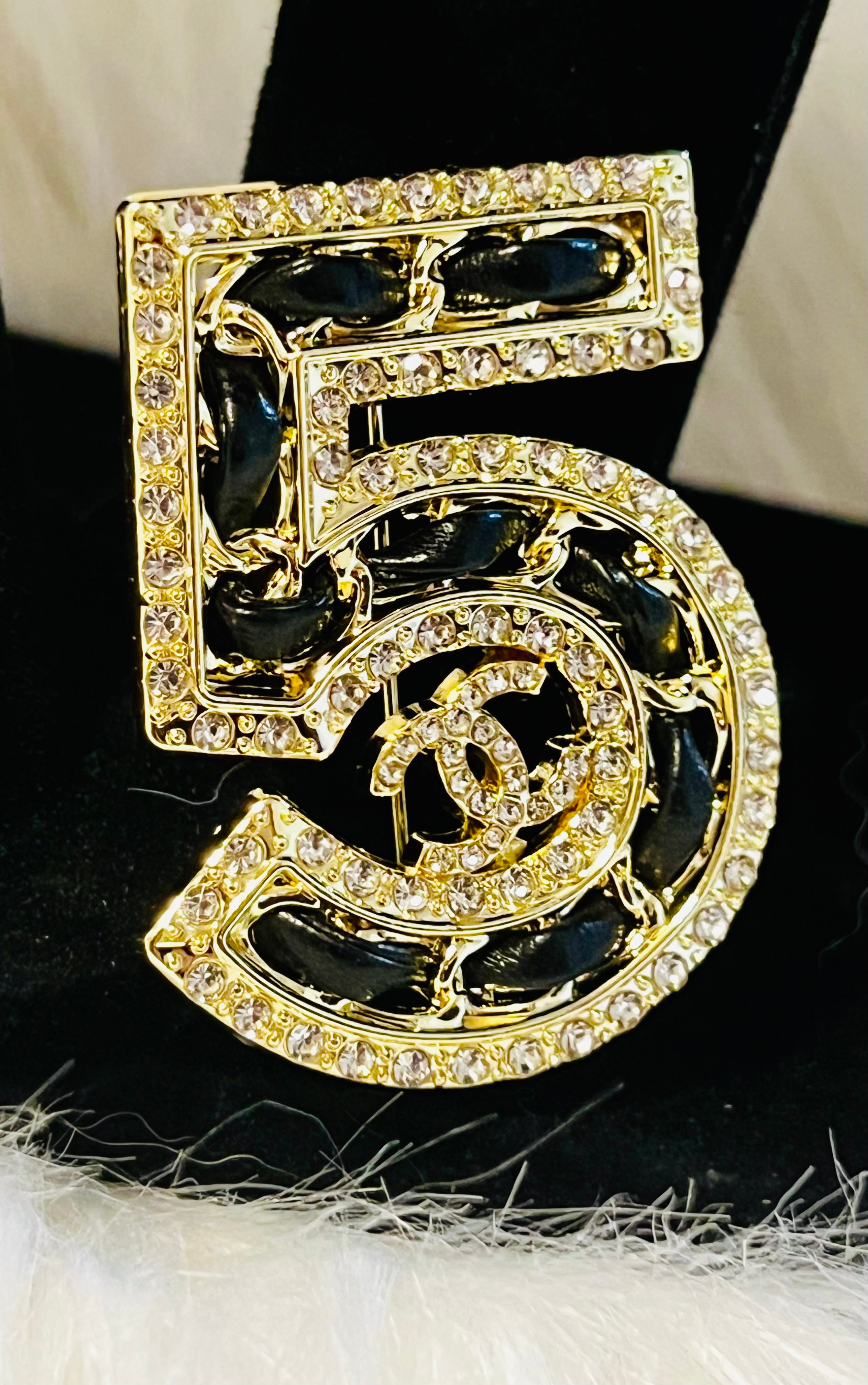 Iconic CHANEL NO 5 Gold with Rhinestone Accent Black Braided Brooch