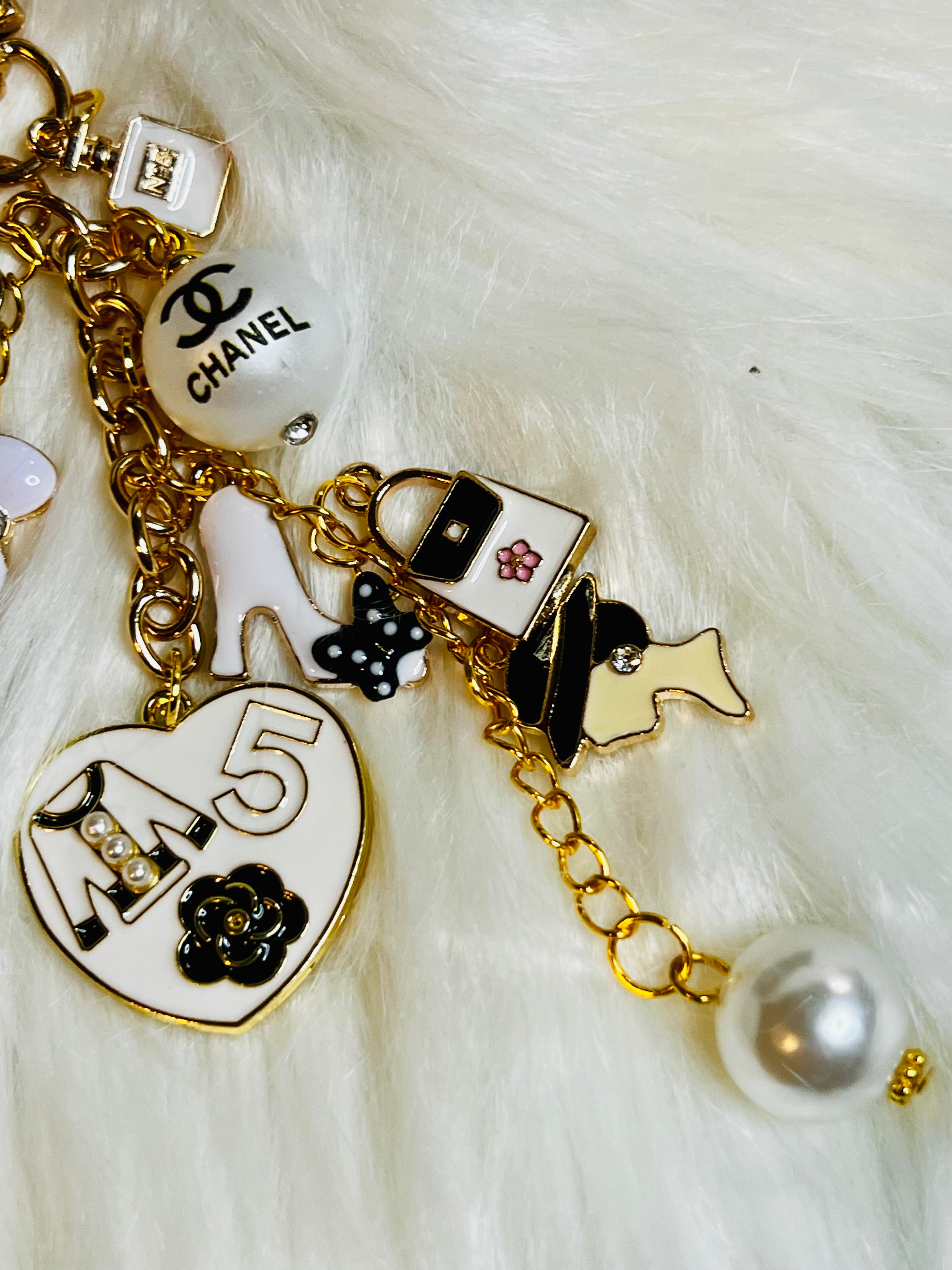 CHANEL Gold, White, and Black Pearl Logo Charm Keychain