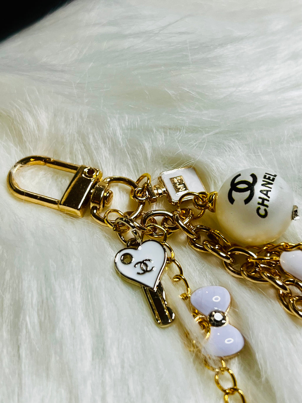 CHANEL Gold, White, and Black Pearl Logo Charm Keychain