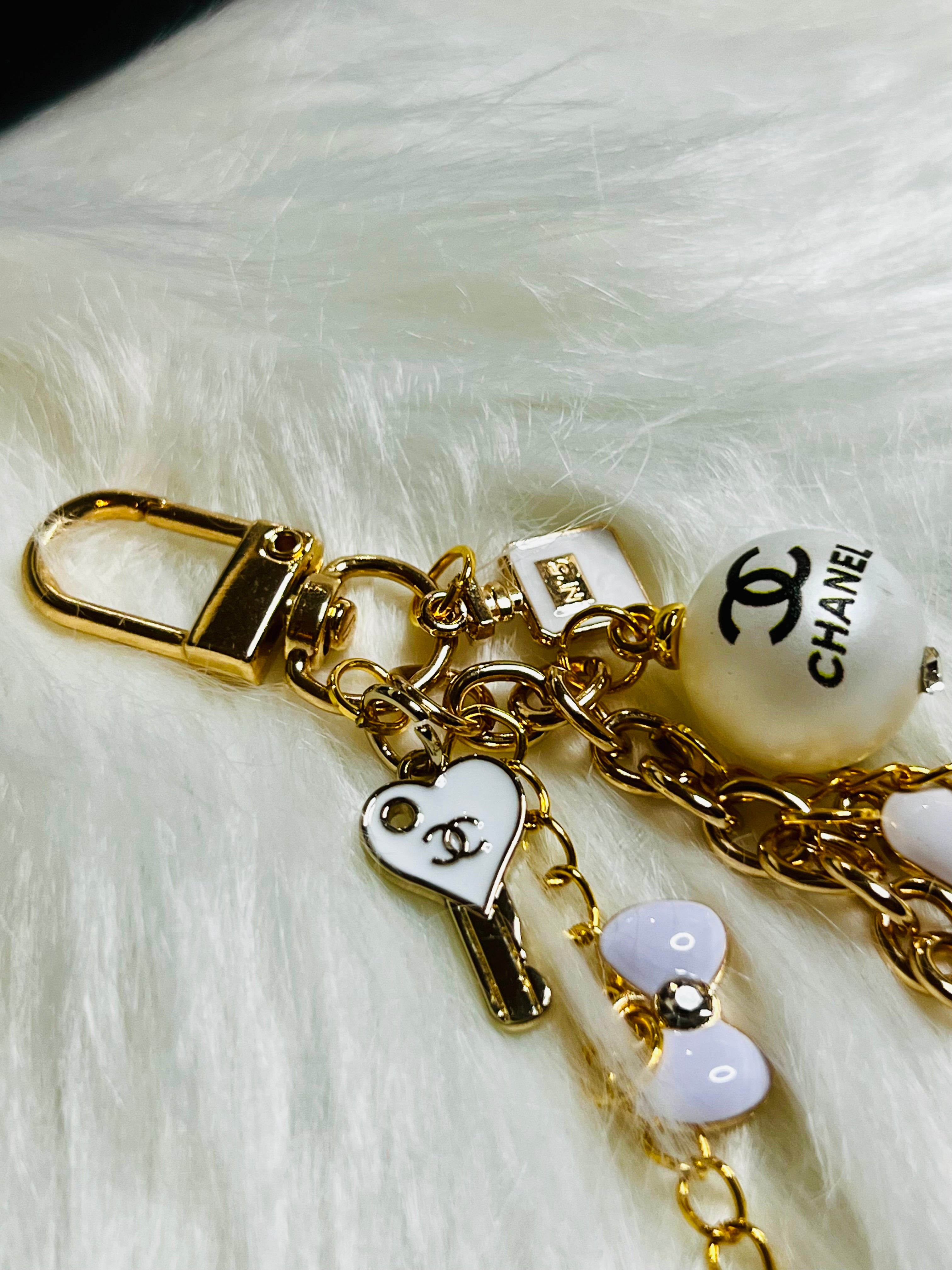 CHANEL Gold, White, and Black Pearl Logo Charm Keychain