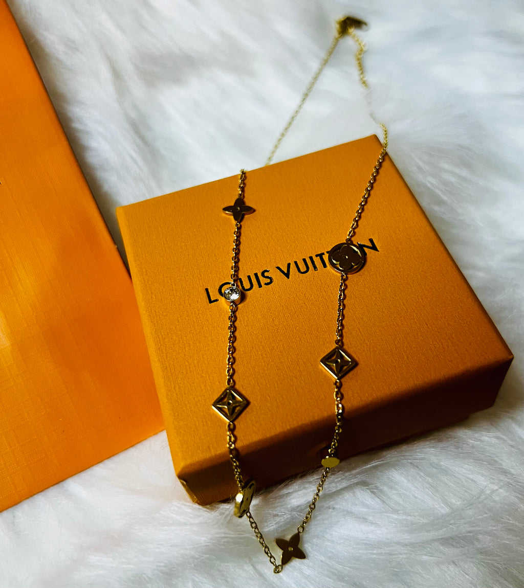 LV Gold Necklace with Crystal Accents and an Intricate Design