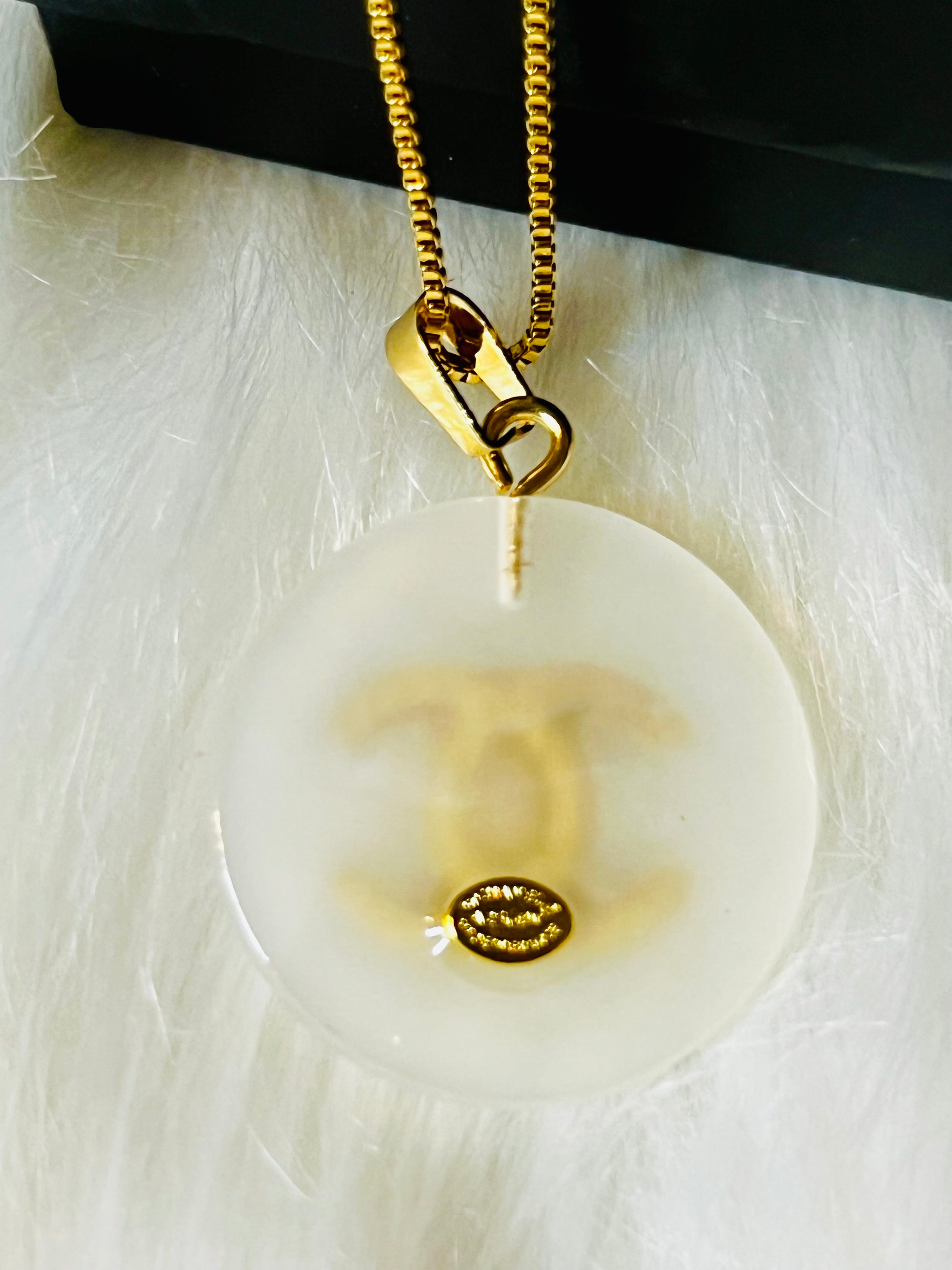 CHANEL White Shell with Gold Lettering Circular Pendant Necklace