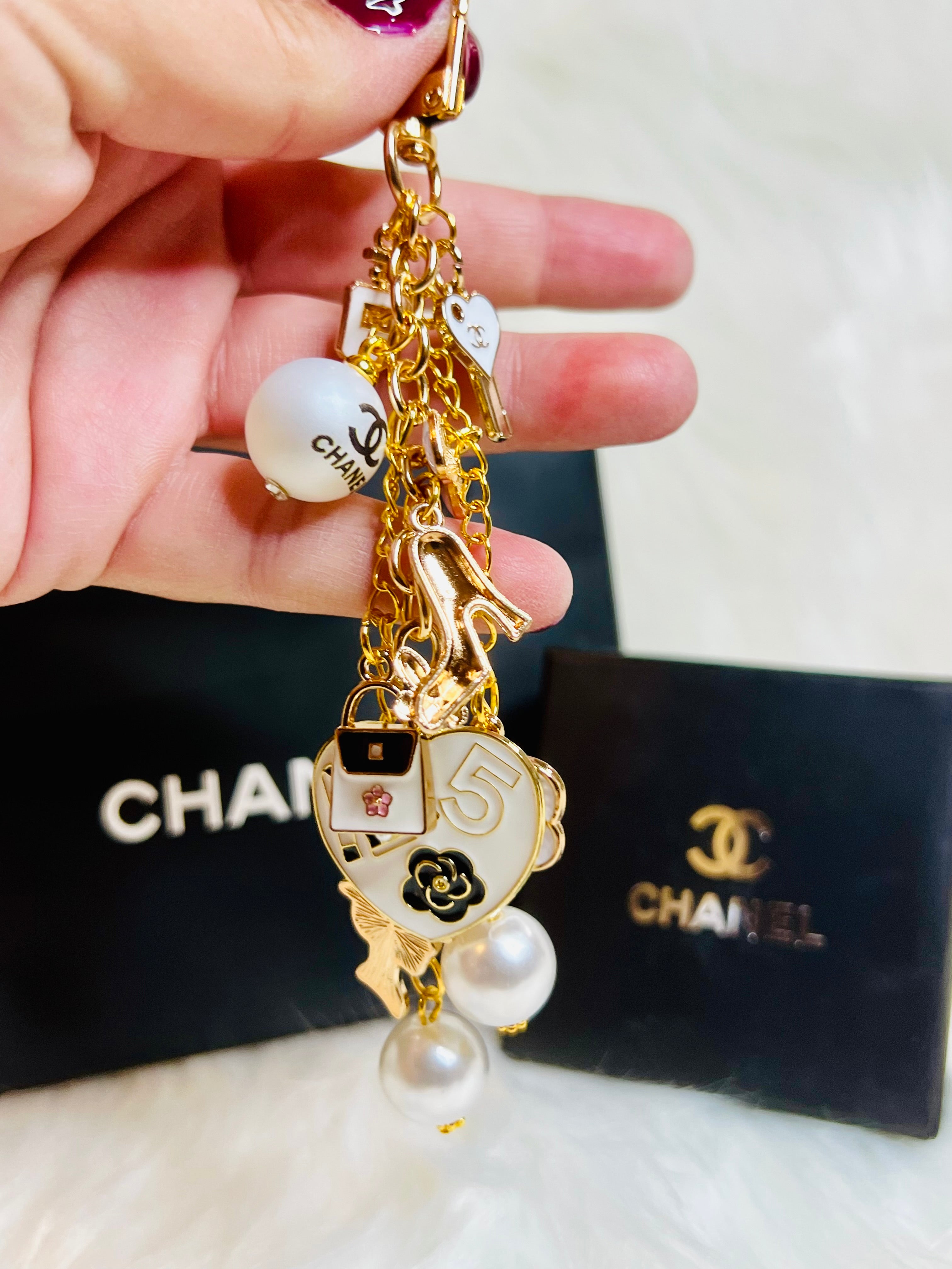 CHANEL Gold, White, and Black Pearl Logo Charm Keychain