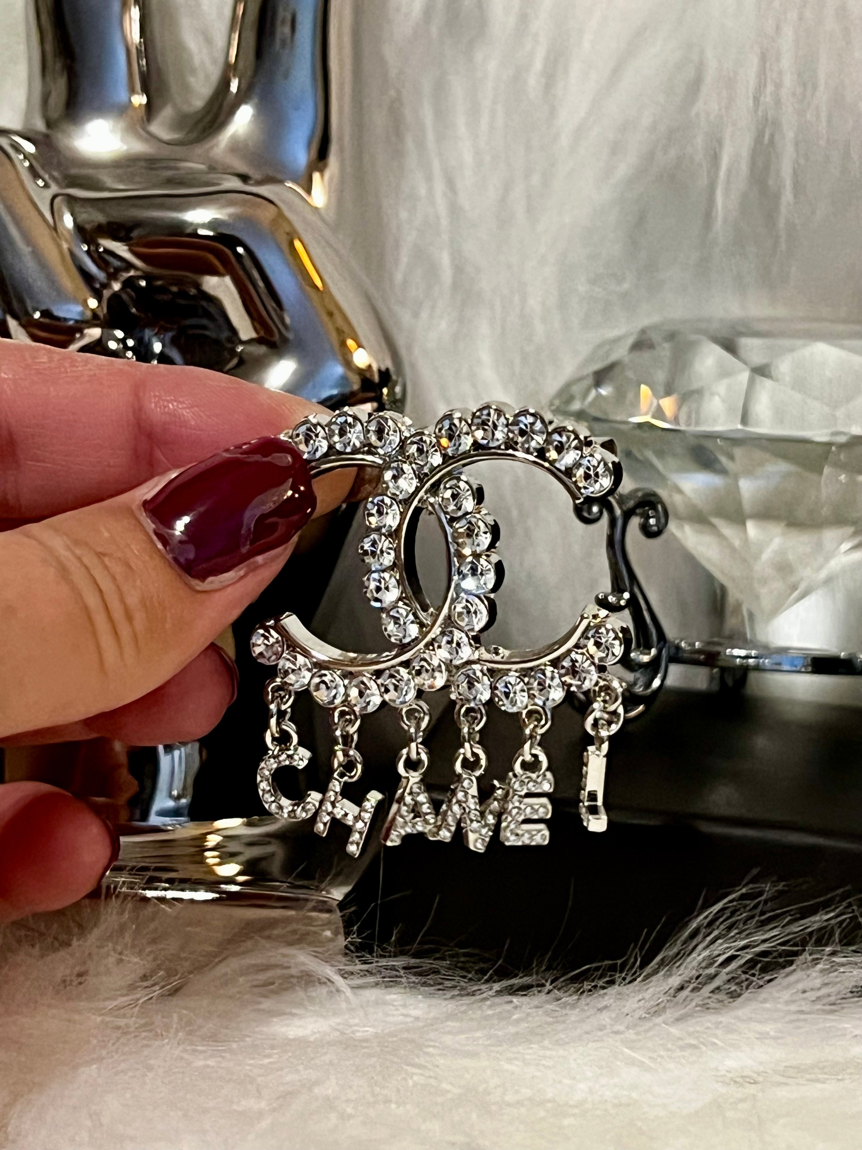 CHANEL Unique Silver Crystal Brooch Featuring Drop Logo E